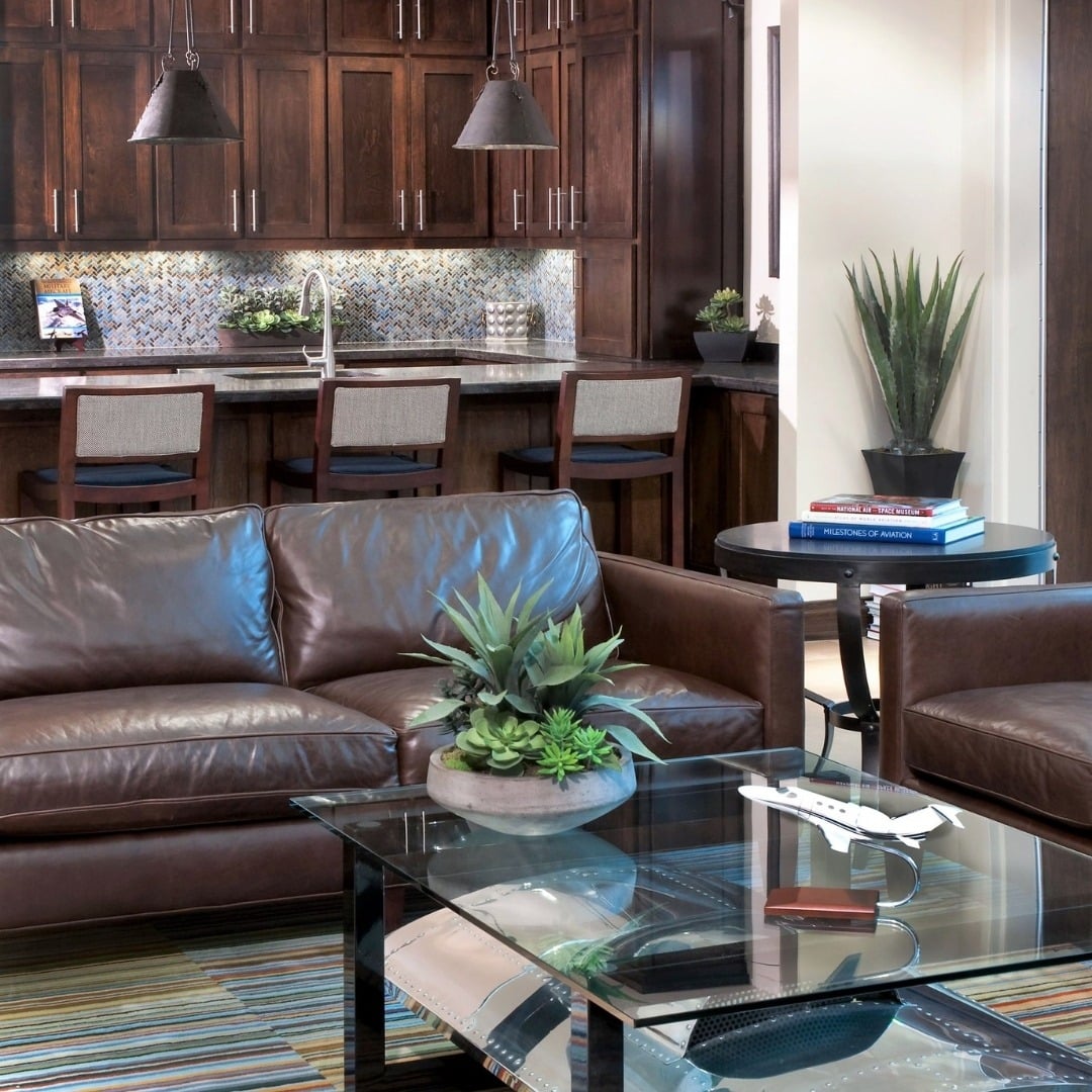 11. Rich Espresso Leather Sofa with Warm Wood Kitchen Backdrop - brown sofa living room ideas