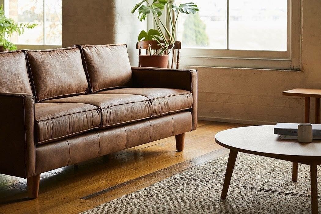 12. Mid-Century Brown Sofa with Light Wood and Neutral Palette - brown sofa living room ideas