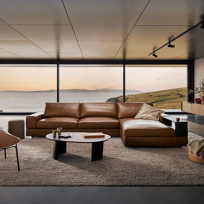 16. Modern Brown Sectional with Panoramic View and Neutral Layers - brown sofa living room ideas