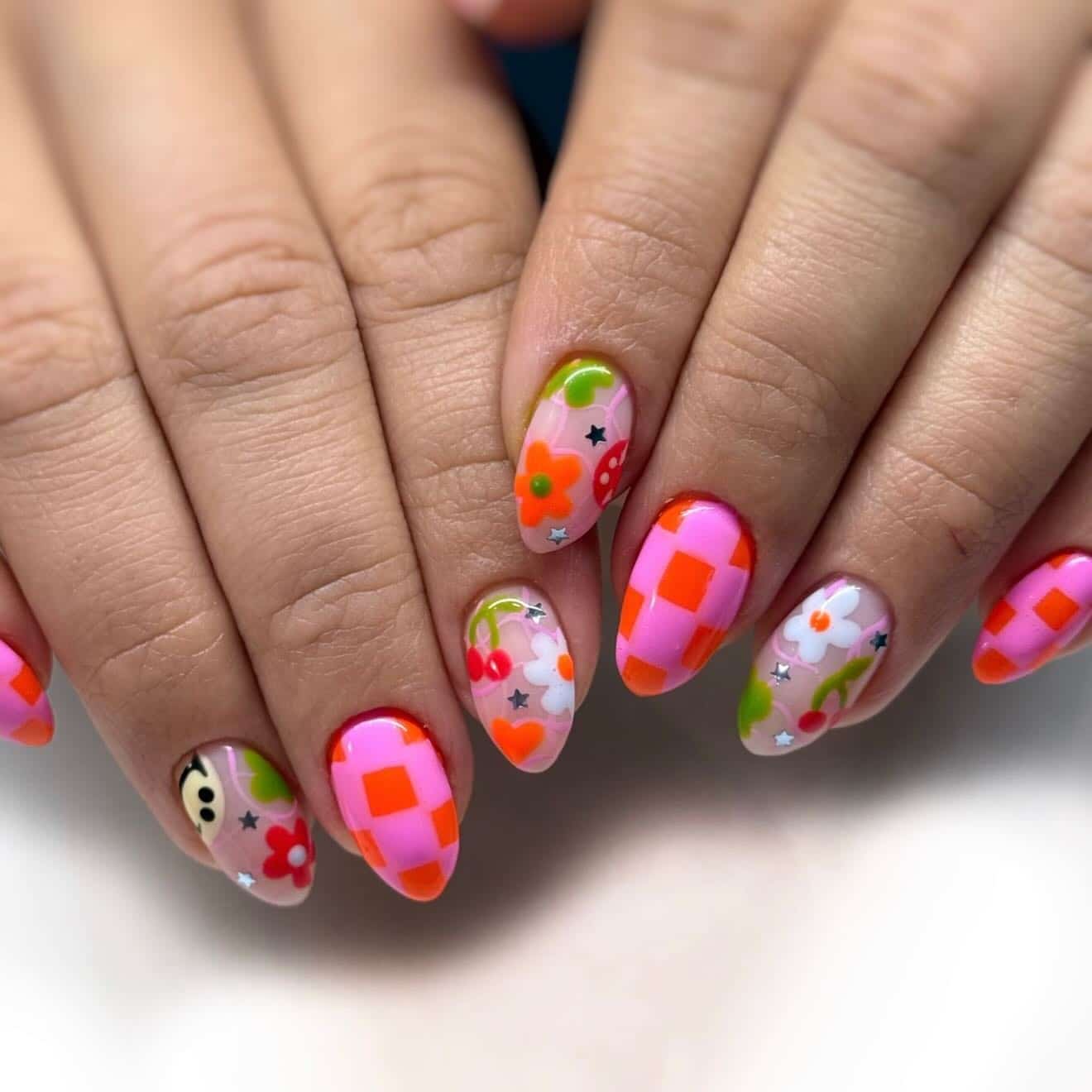 6. Retro Floral and Checkerboard Almond Nails in Pink and Orange - summer nail ideas