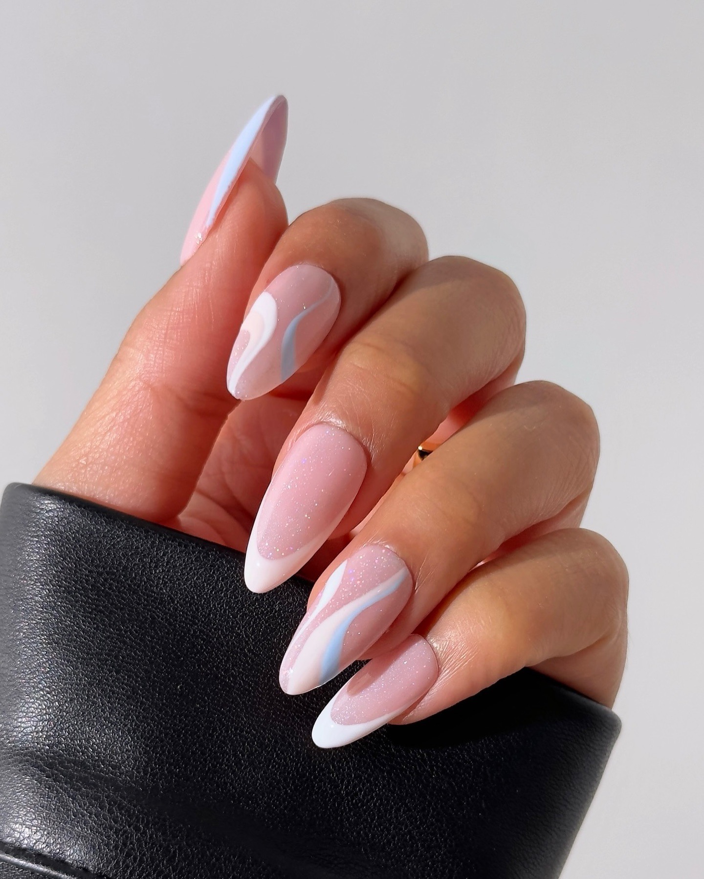 16. Milky Pink Almond Nails with Soft White Swirl Design - summer nail ideas