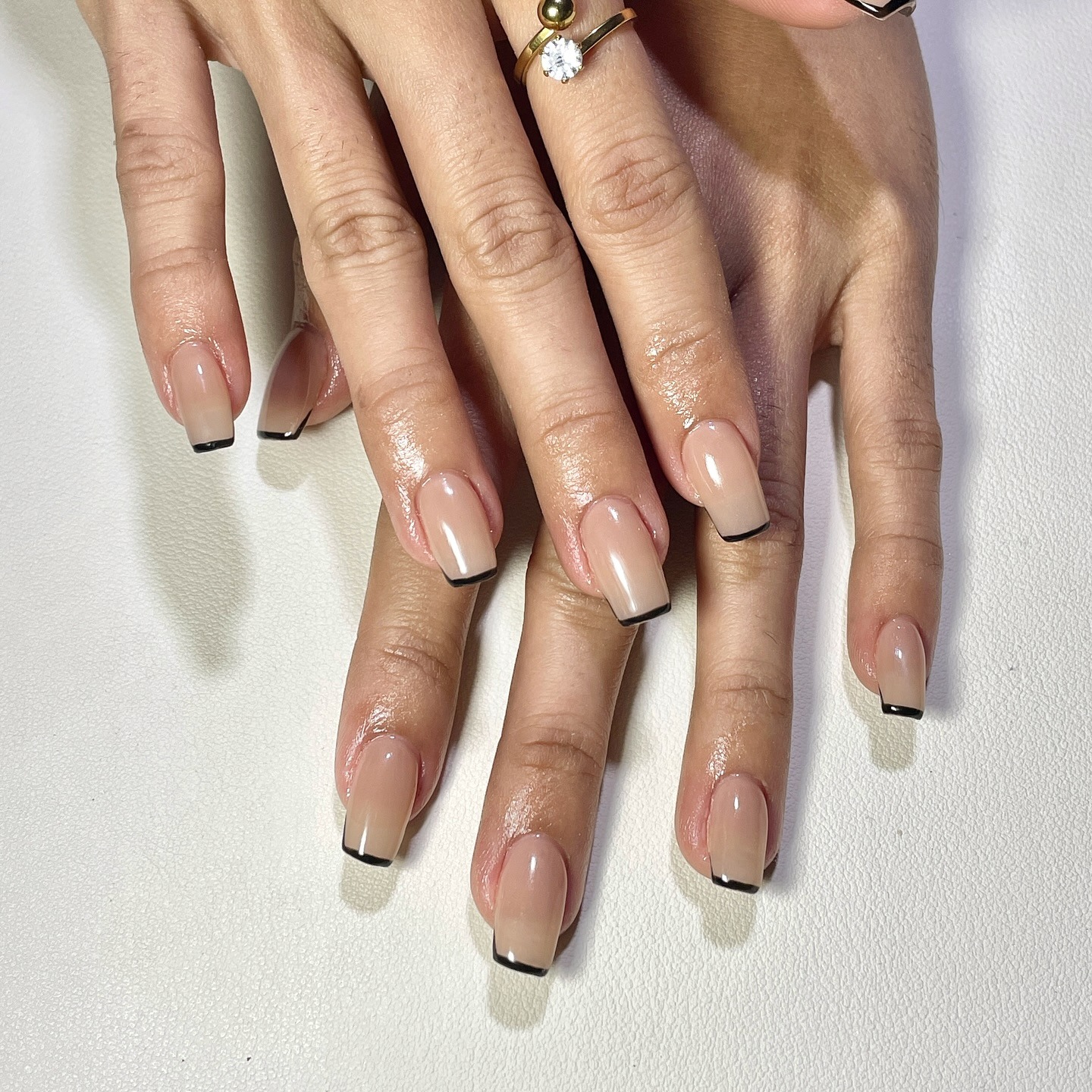 18. Neutral Gloss Coffin Nails with Black Tips - small coffin nail ideas