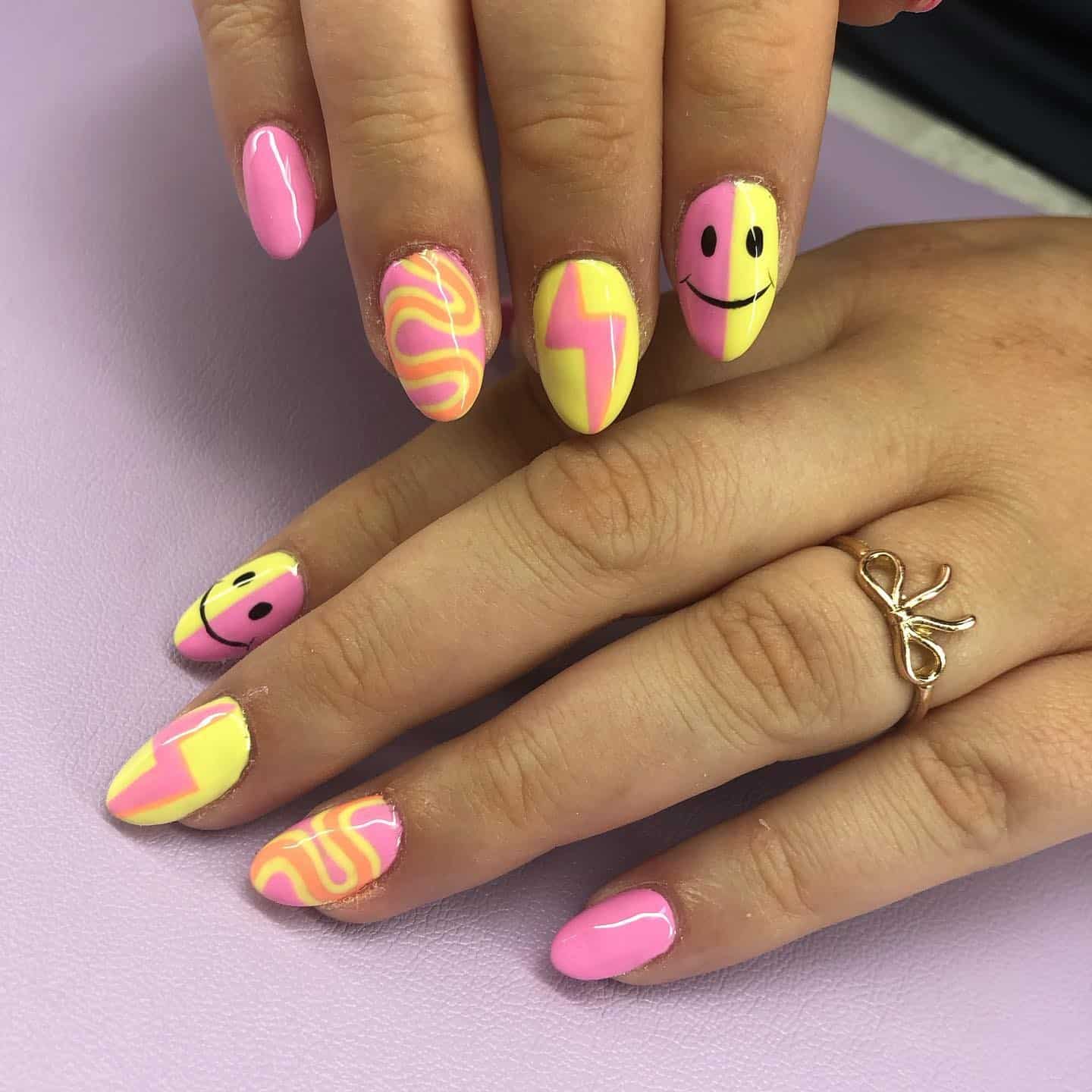 4. Retro Pink and Yellow Abstract Almond Nails with Smiley Accent - yellow and pink nail ideas