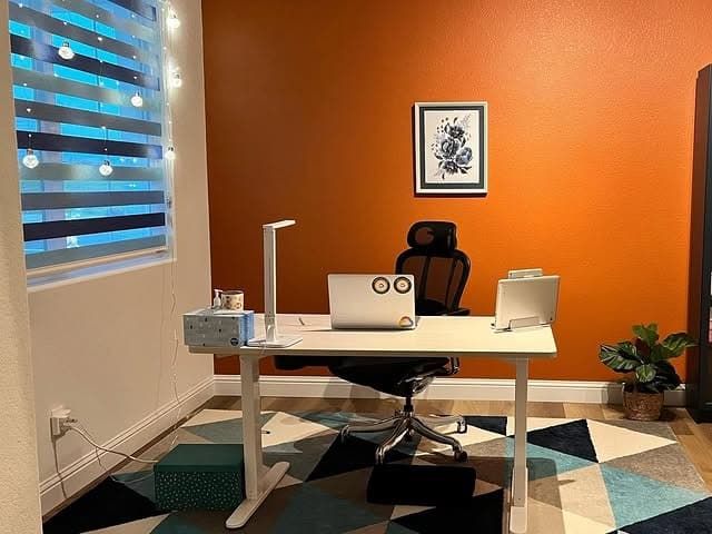 9. Bold Orange Accent Wall for Energetic Workspace - accent wall office ideas