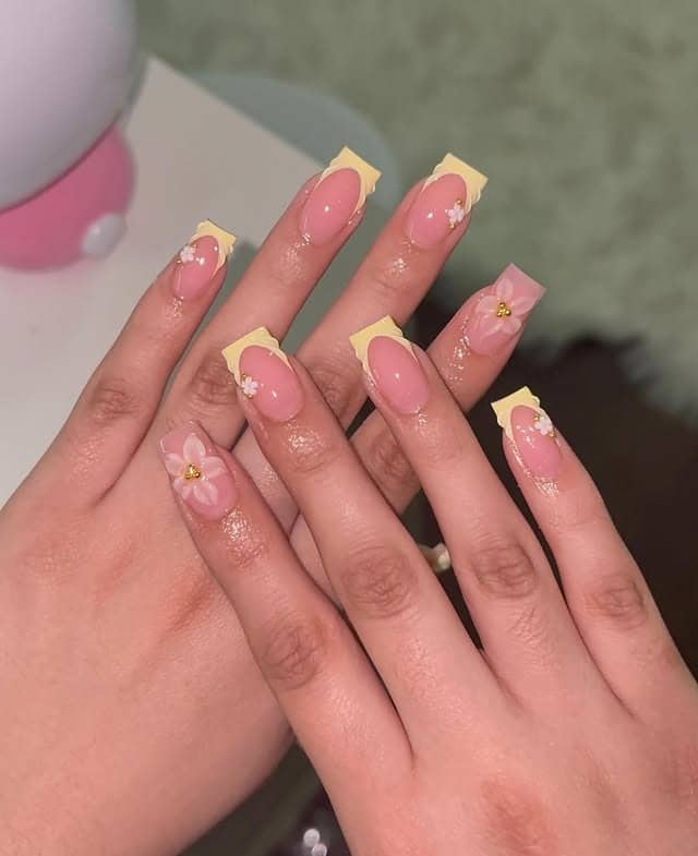 1. Pastel Yellow French Tips with Floral Accents - spring nail ideas