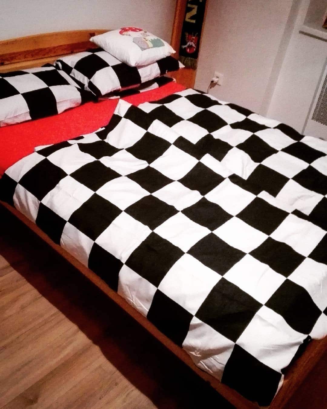 7. Contemporary Concrete Bedroom with Red Highlights - red, black and white bedroom ideas