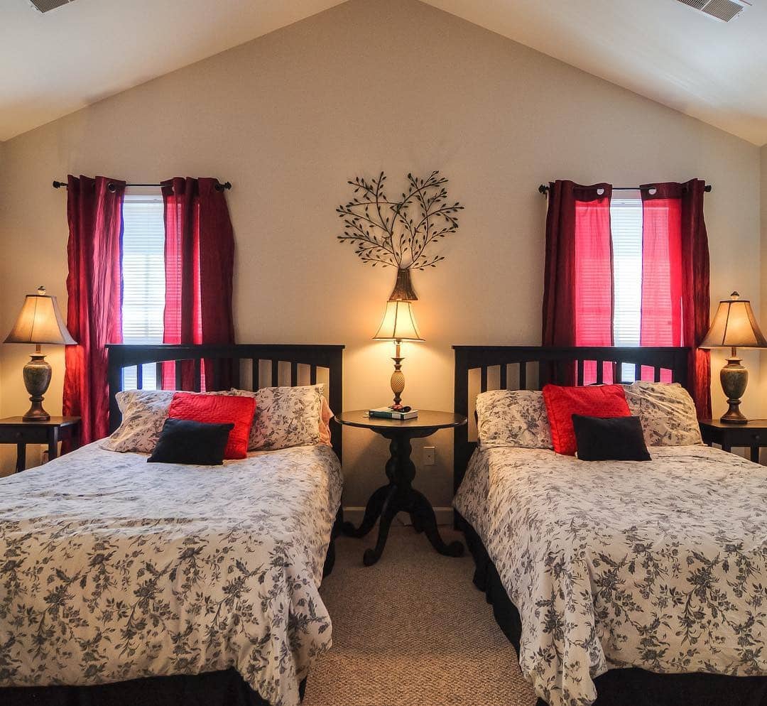12. Classic Twin Bedroom with Red Drapery and Black Wood - red, black and white bedroom ideas