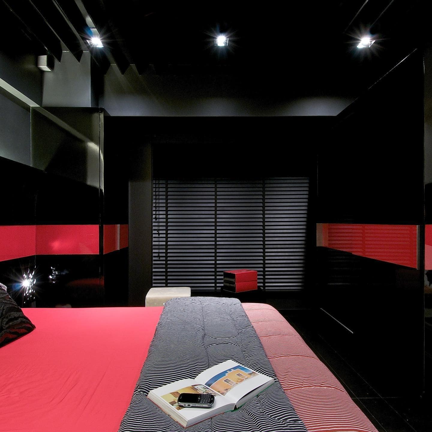 15. Sleek Black Bedroom with Red Horizontal Accents - red, black and white bedroom ideas