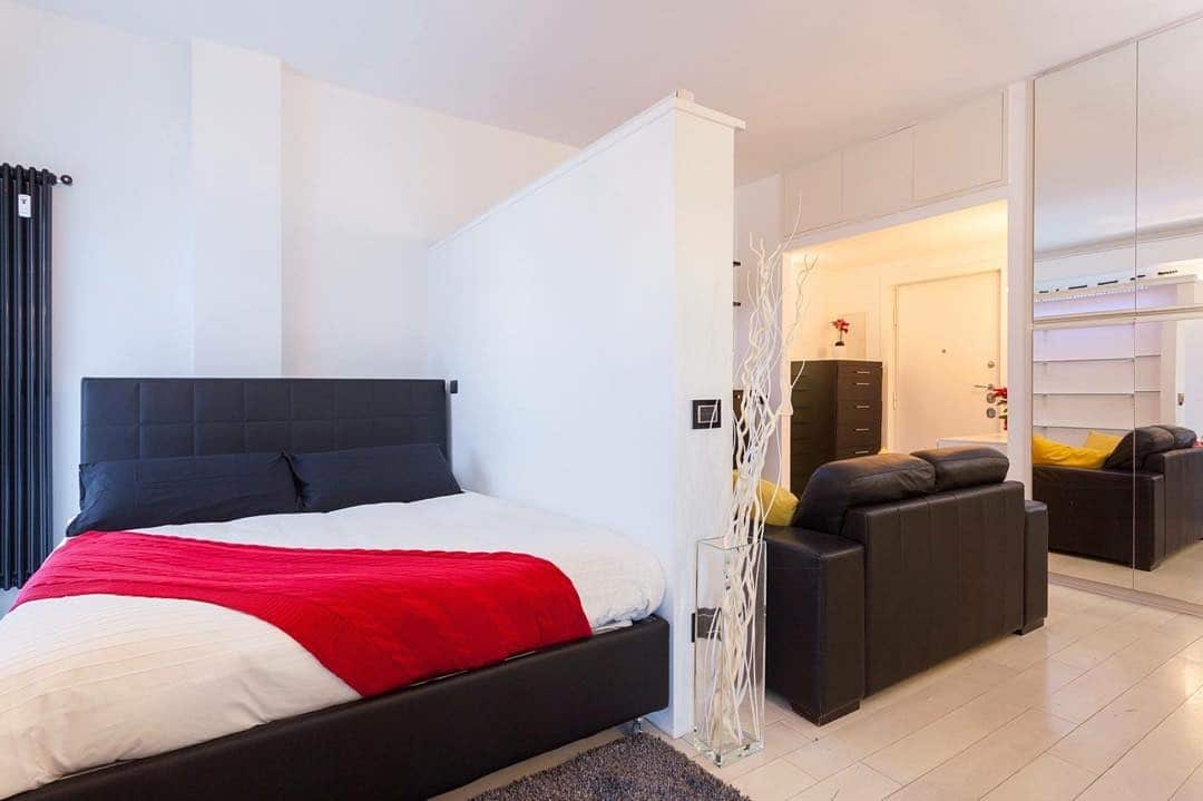 18. Open-Concept Bedroom with Red Throw and Black Leather - red, black and white bedroom ideas