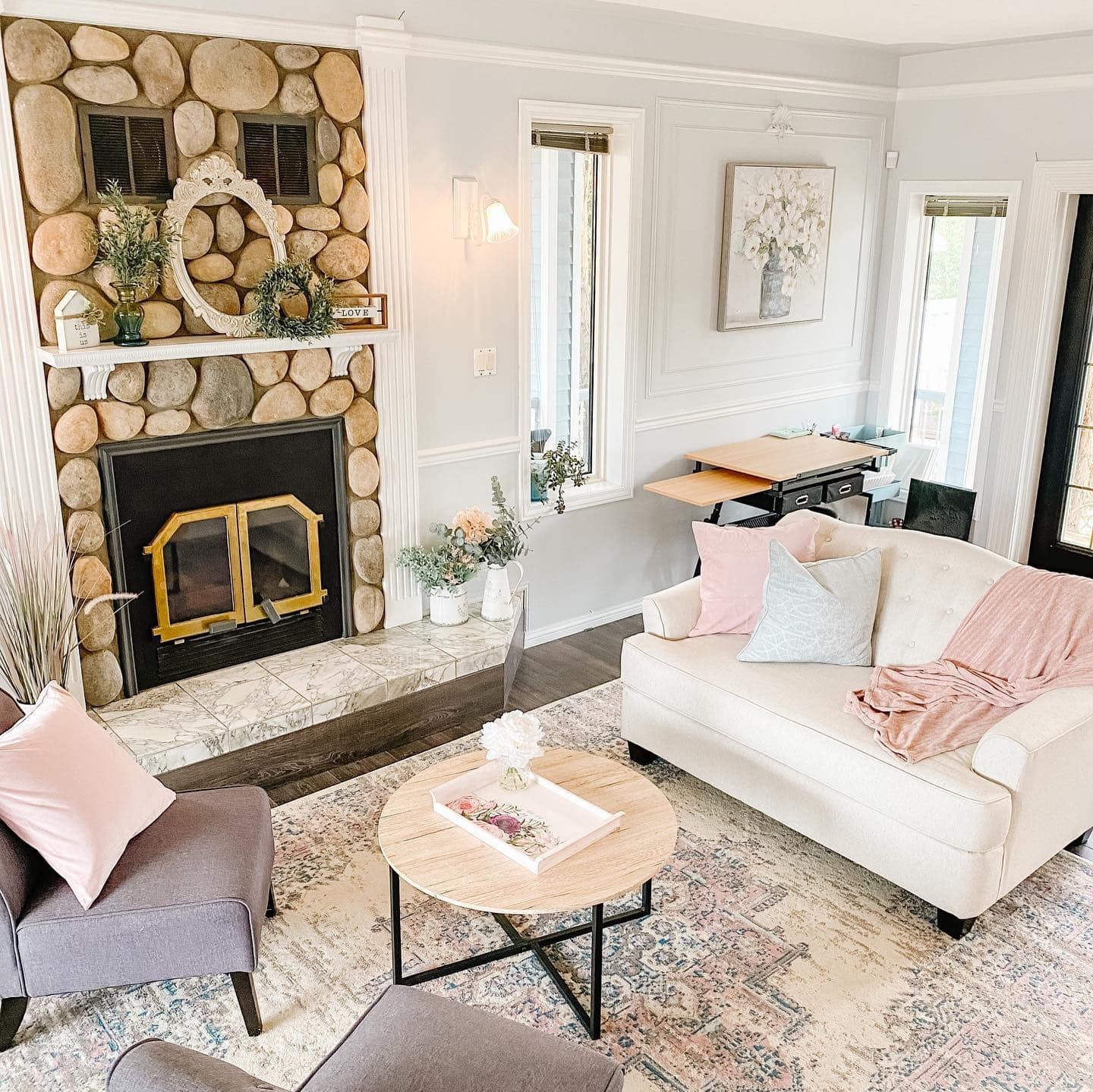 2. Rustic Stone Fireplace with Blush and Cream Accents - french country living room ideas