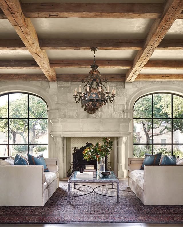 7. Grand French Country with Exposed Beams and Stone Fireplace - french country living room ideas