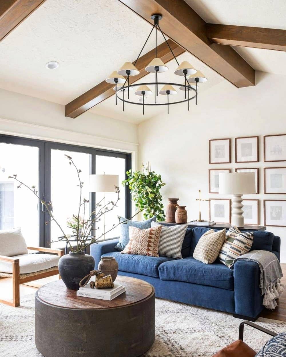 12. Rustic Beam Living Room with Blue and Warm Wood Accents - french country living room ideas