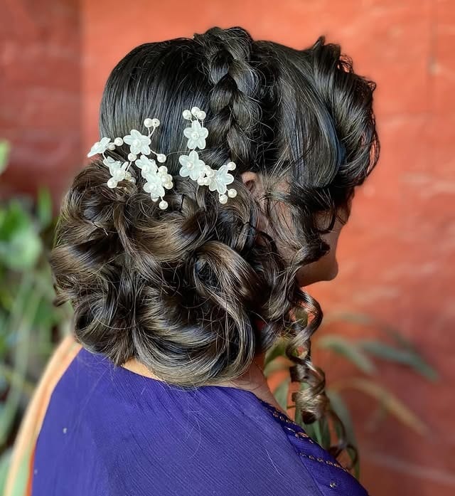 4. Voluminous Dark Chocolate Curled Bun with Decorative Pins - Messy Bun Hairstyles