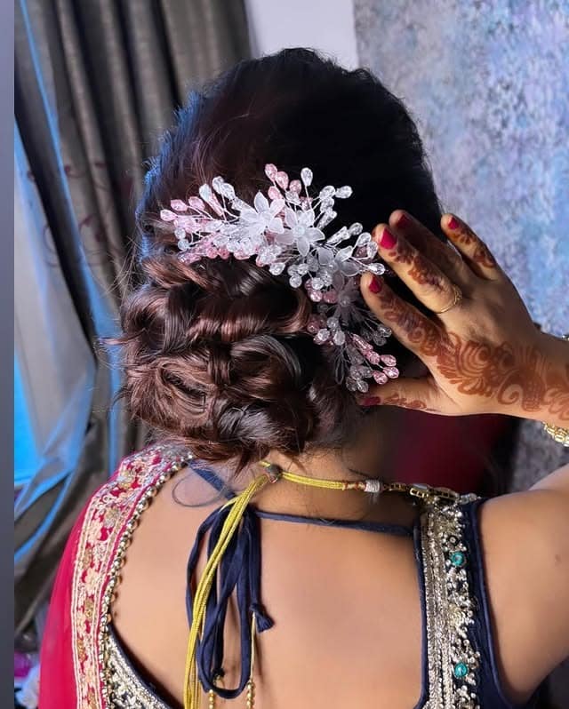 6. Deep Brunette Braided Low Bun with Crystal Accessory - Messy Bun Hairstyles