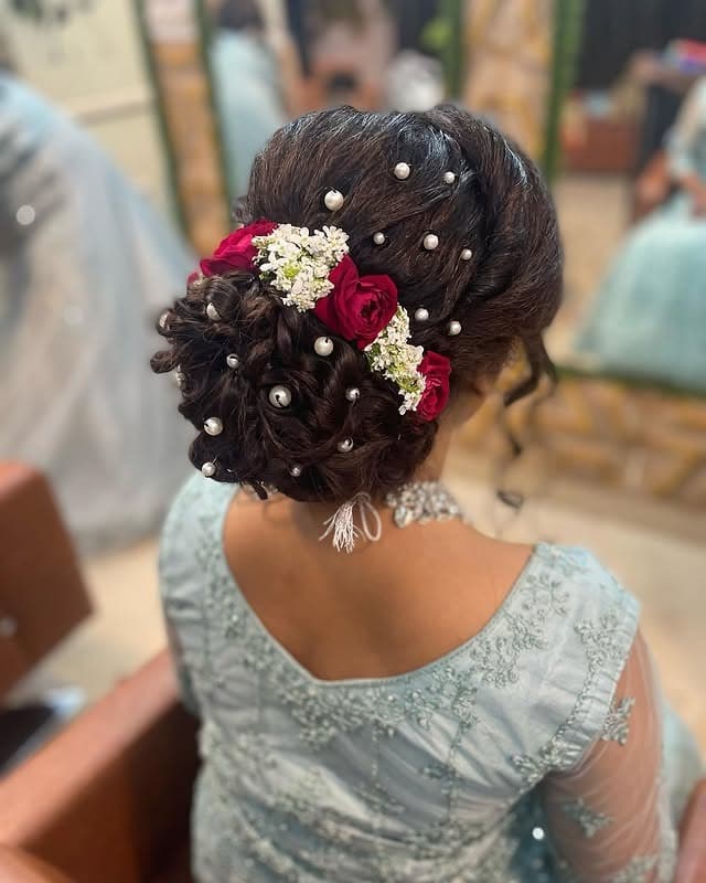 8. Classic Brunette Floral Bun with Rose Accents - Messy Bun Hairstyles