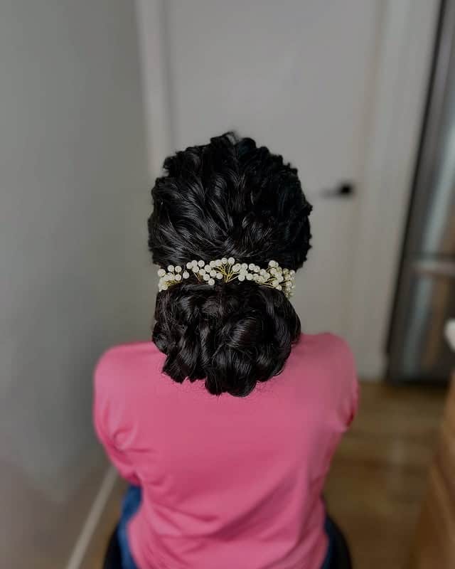 9. Sleek Black Braided Low Bun with Minimalist Clip - Messy Bun Hairstyles
