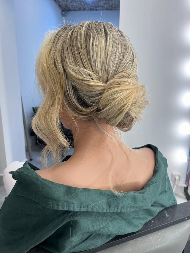 11. Soft Ash Blonde Twisted Low Messy Bun - Messy Bun Hairstyles