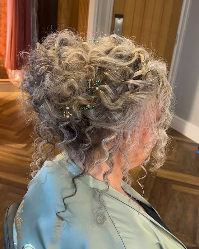 13. Silver Blonde Curly Textured Messy Bun with Hair Pins - Messy Bun Hairstyles
