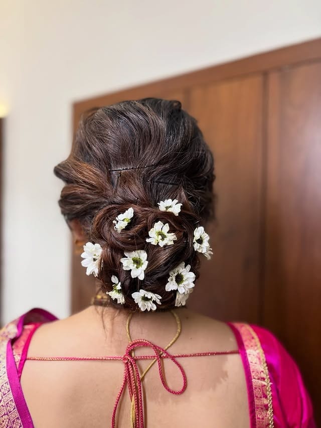 14. Rich Brunette Floral Low Messy Bun - Messy Bun Hairstyles