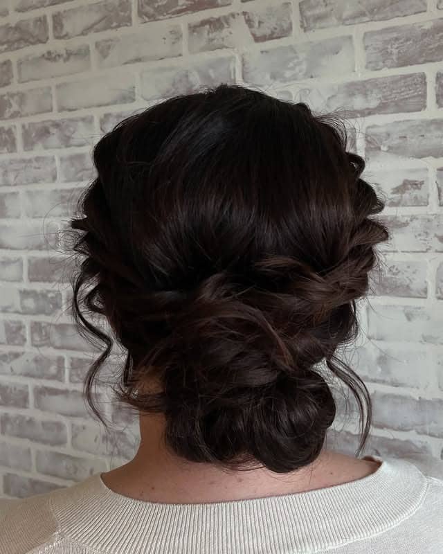 15. Deep Chocolate Twisted Low Messy Bun - Messy Bun Hairstyles
