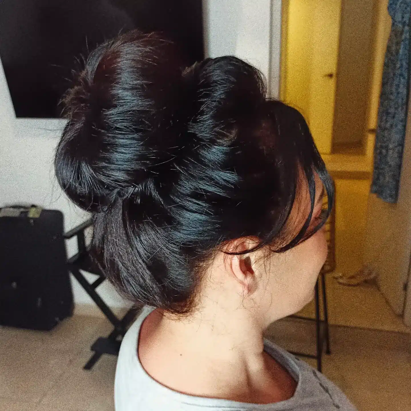 16. Jet Black Sculpted Double Roll Messy Bun - Messy Bun Hairstyles