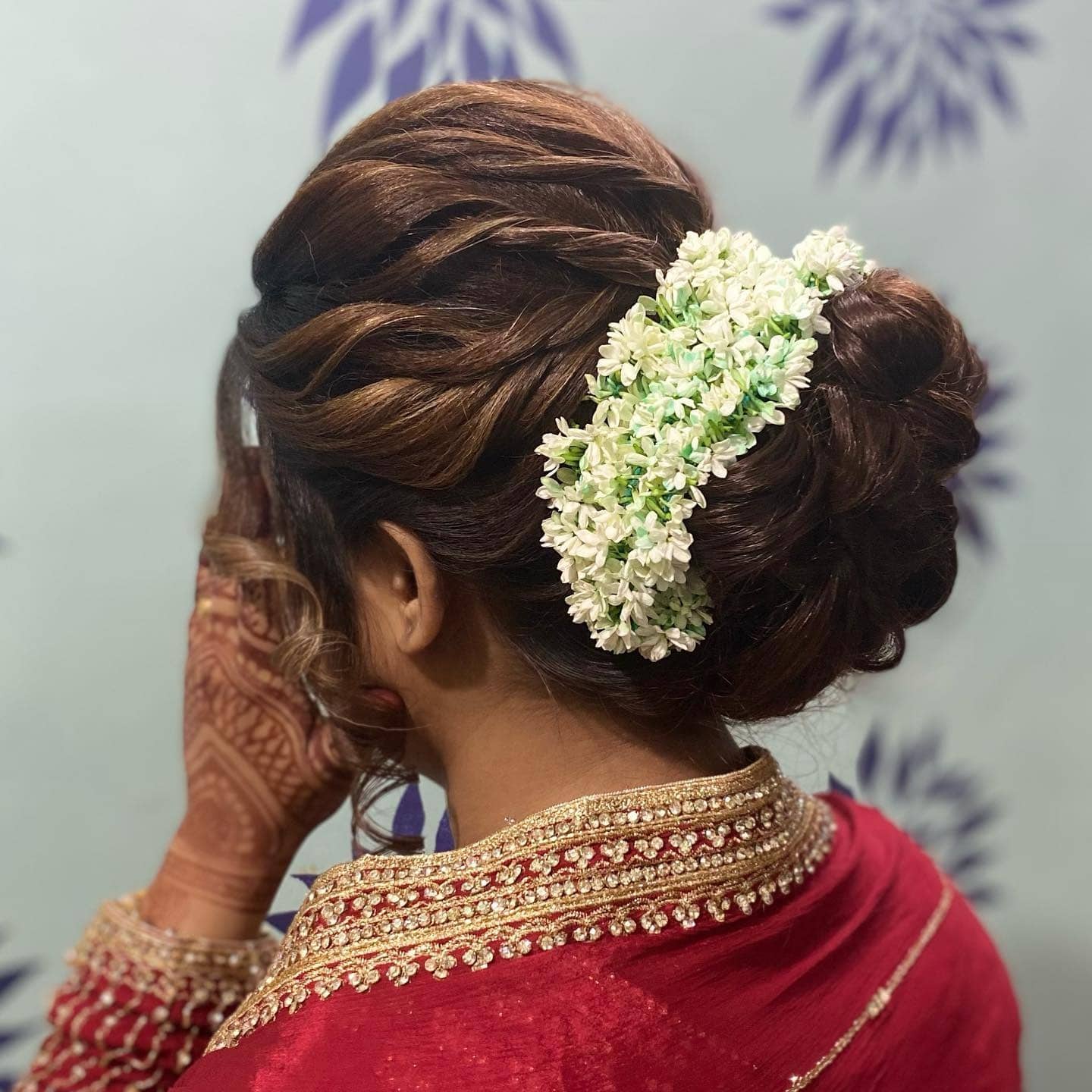 19. Chestnut Brown Sleek Floral Low Messy Bun - Messy Bun Hairstyles