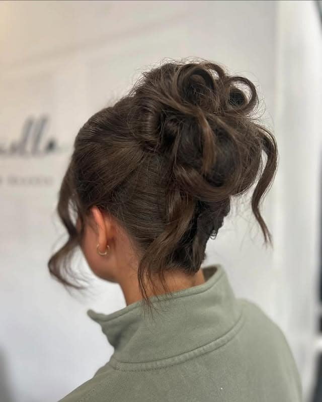 22. Soft Brunette Textured High Messy Bun with Loose Tendrils - Messy Bun Hairstyles