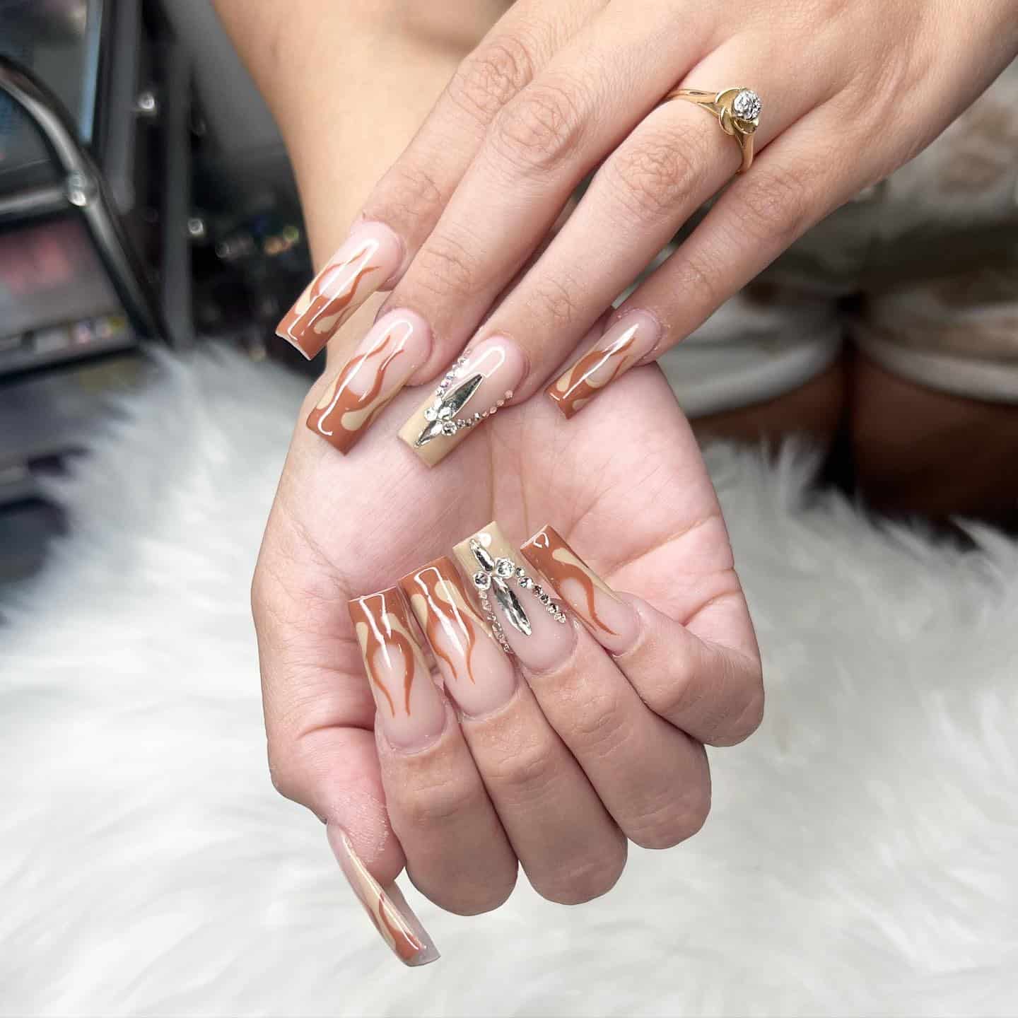 4. Brown Swirl Rhinestone Coffin Nails - first day of school nail ideas
