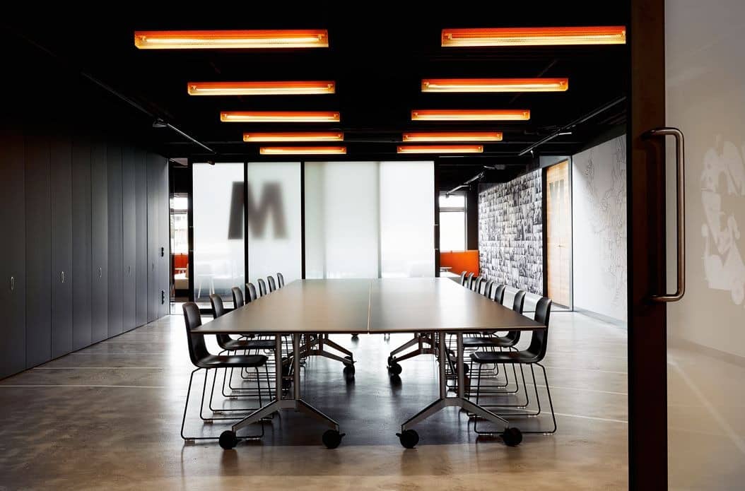 4. Industrial Conference Room With Amber Lighting - creative office ideas