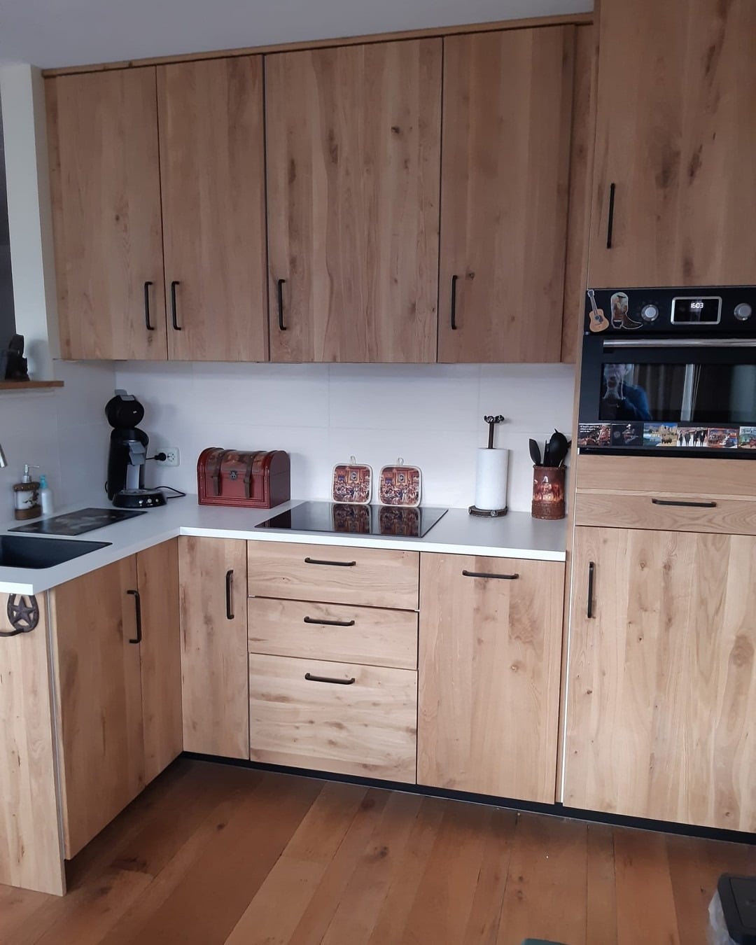 12. Natural Wood Corner Kitchen With Matte Black Hardware - corner kitchen ideas