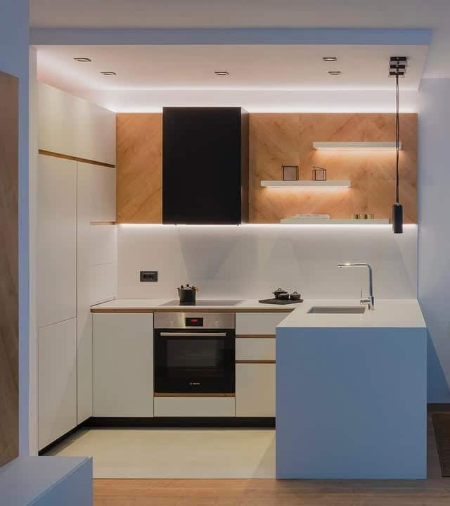 19. White and Wood Corner Kitchen With Ambient Lighting - corner kitchen ideas