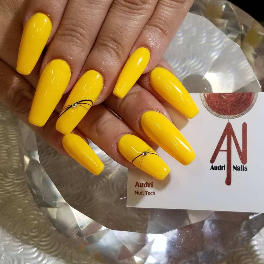 4. Bright Yellow Coffin Nails with Minimal Line Art - yellow coffin nail ideas