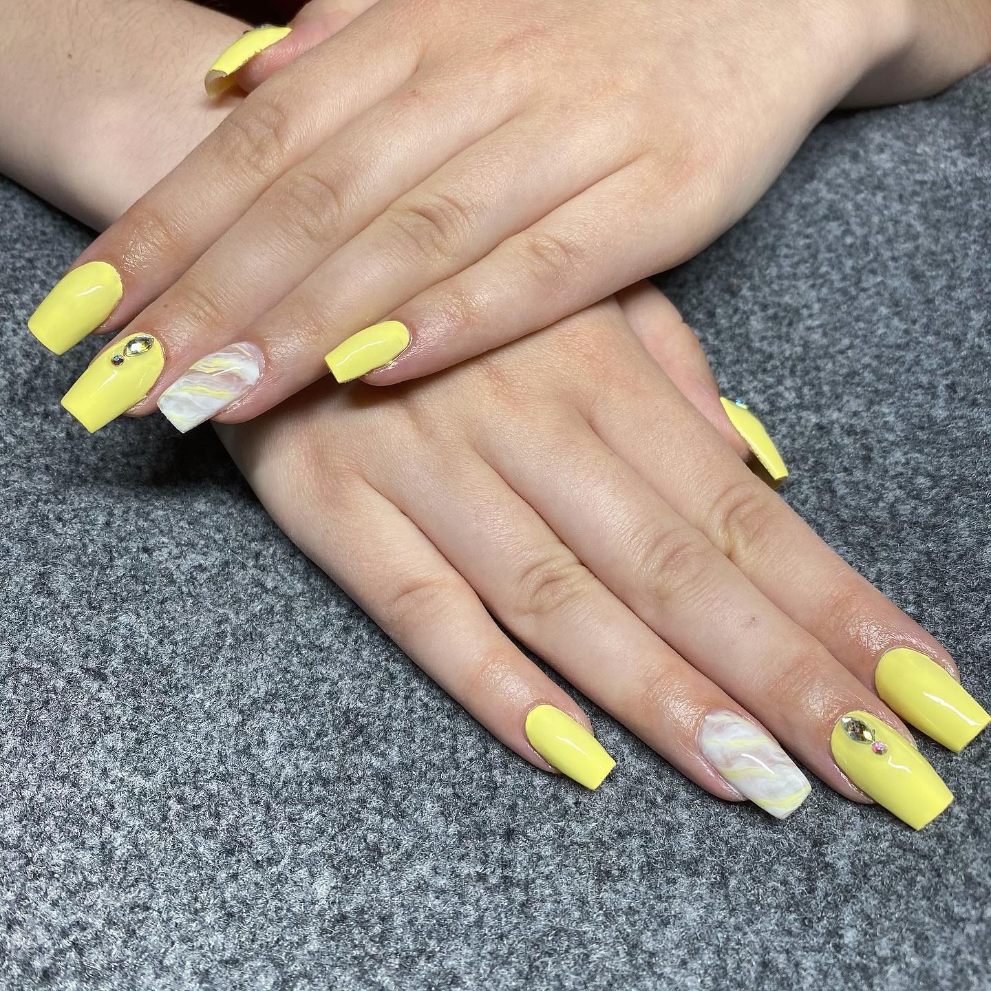 10. Soft Yellow Marble Accent Coffin Nails - yellow coffin nail ideas