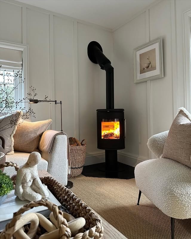13. Neutral Cottage Living Room with Black Wood Stove - cottage living room ideas