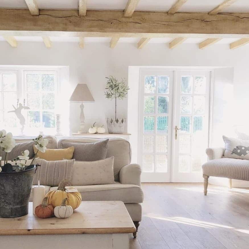 18. Bright Neutral Cottage Living Room with Exposed Beams - cottage living room ideas