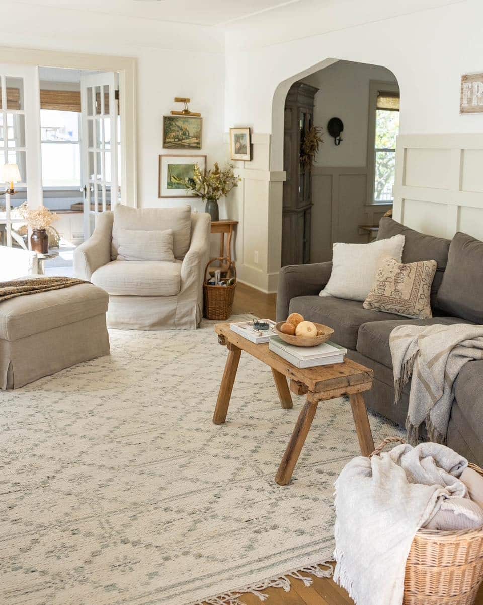 22. Cream and Charcoal Cottage Living Room with Vintage Details - cottage living room ideas
