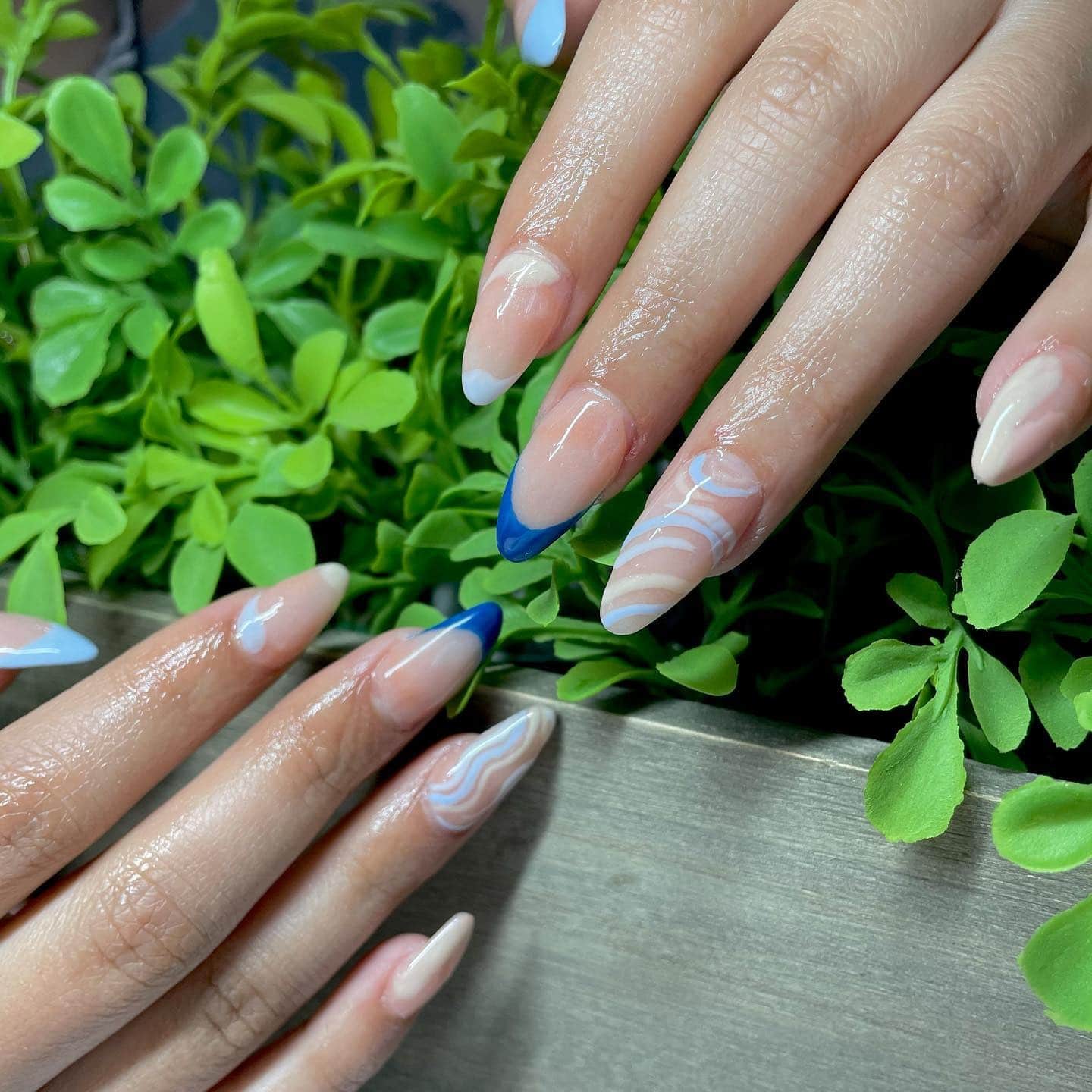 6. Nude and Blue Swirl French Tip Nails - zig zag nail ideas