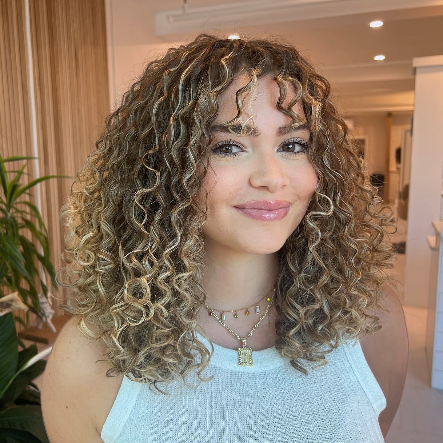 3. Defined Spiral Curls with Honey Blonde Ribbons - Wispy Bangs For Curly Hair