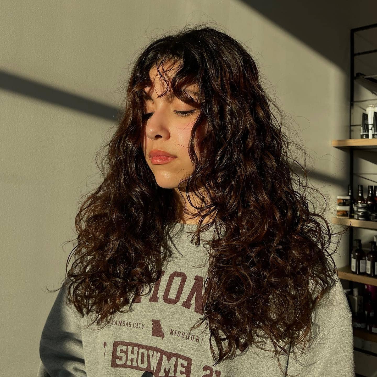 7. Long Curly Layers with Dark Chocolate Brown Finish - Wispy Bangs For Curly Hair