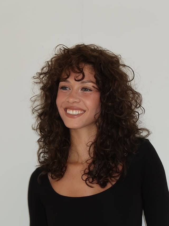 8. Short Curly Bob with Rich Cocoa Brown Tone - Wispy Bangs For Curly Hair