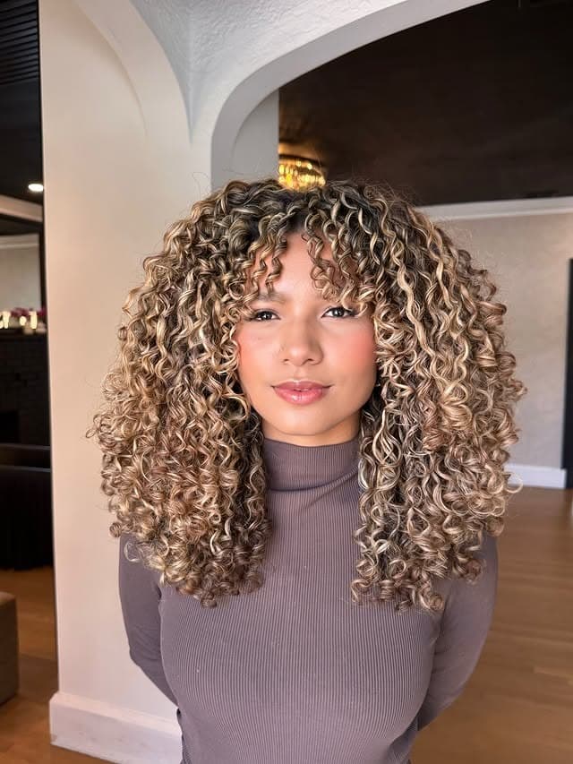 14. Voluminous Defined Curls with Beige Blonde Highlights - Wispy Bangs For Curly Hair
