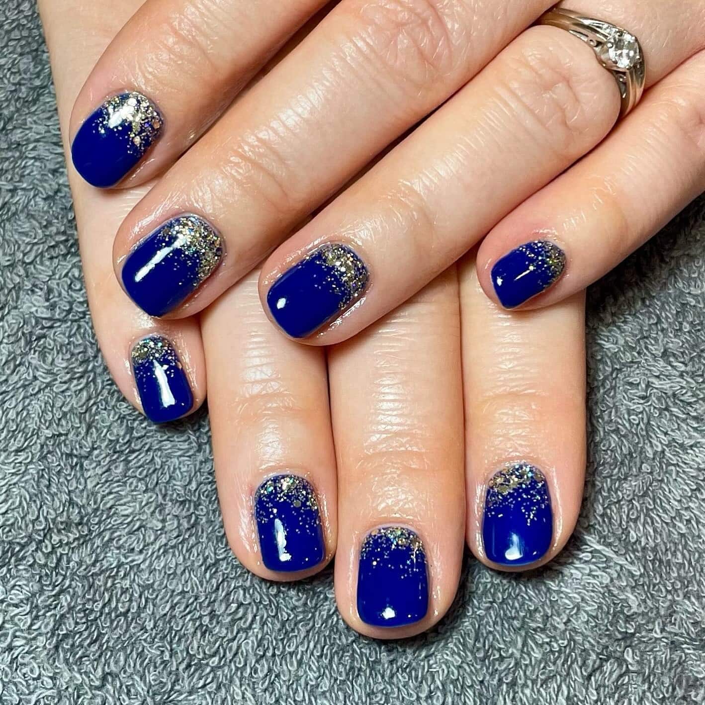 1. Royal Blue Glitter Fade Nails - navy and gold nail ideas