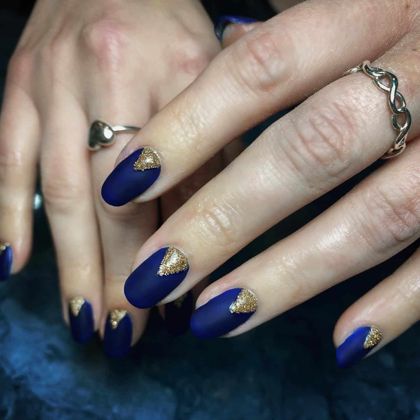 7. Matte Navy Gold Triangle Nails - navy and gold nail ideas