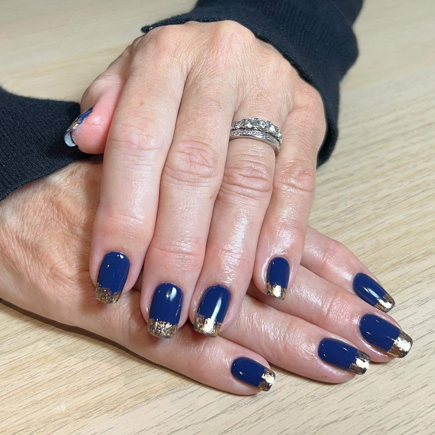 11. Navy Blue Gold Foil French Tip Nails - navy and gold nail ideas