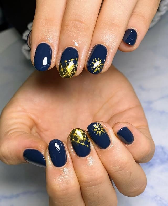 14. Navy and Gold Celestial Accent Nails - navy and gold nail ideas