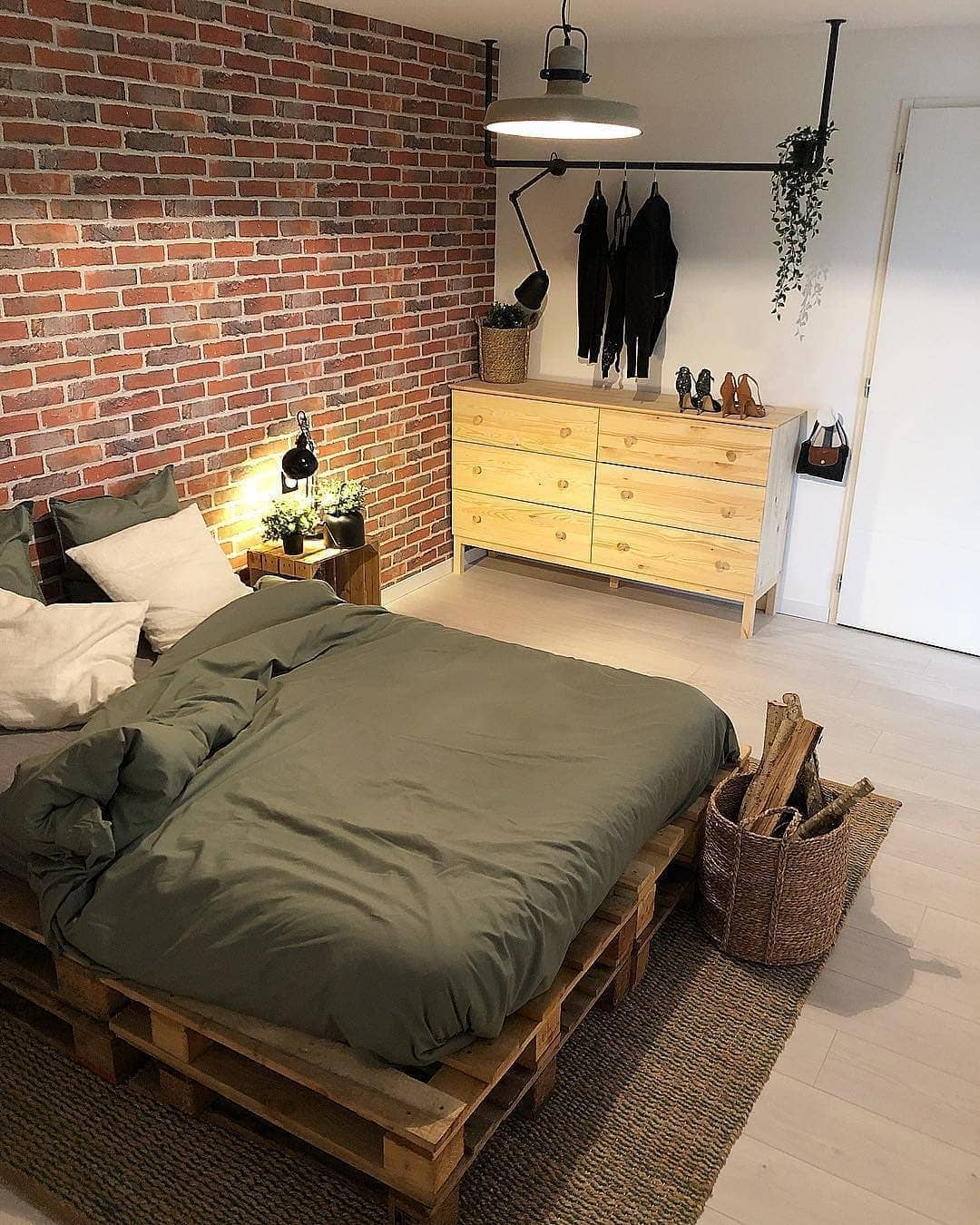 16. Rustic Brick Industrial Bedroom with Olive Green Bedding - industrial bedroom ideas
