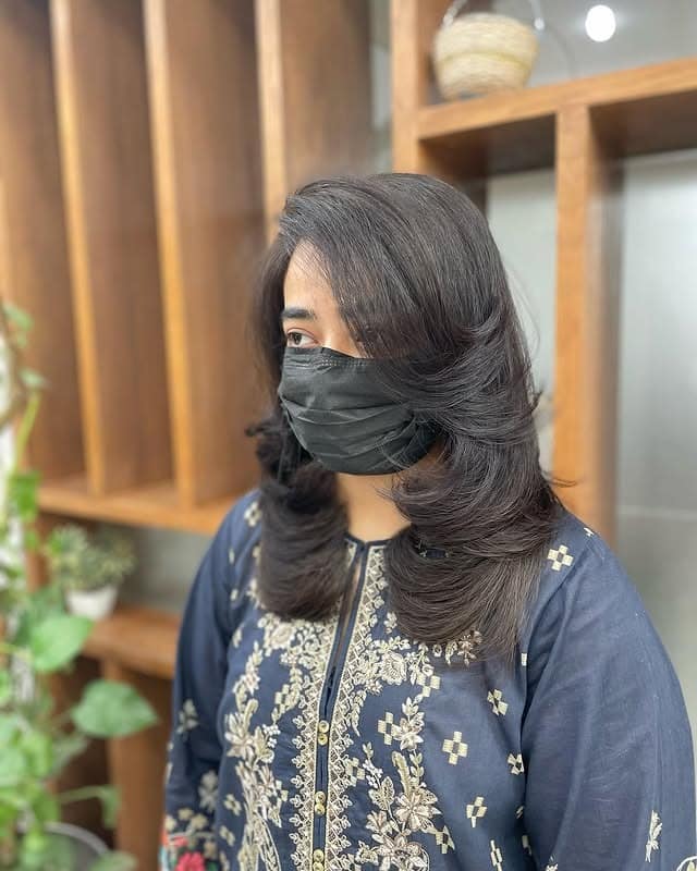 2. Soft Volumized Feather Blowout in Natural Black - Feather Haircuts For Women