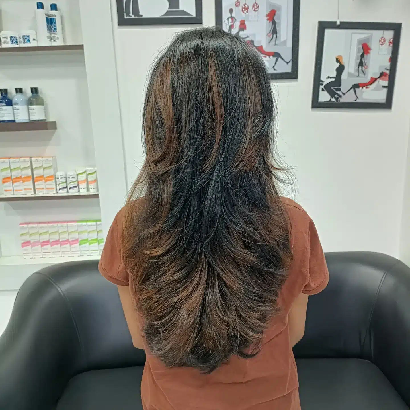 7. Textured Butterfly Feather Layers with Caramel Highlights - Feather Haircuts For Women