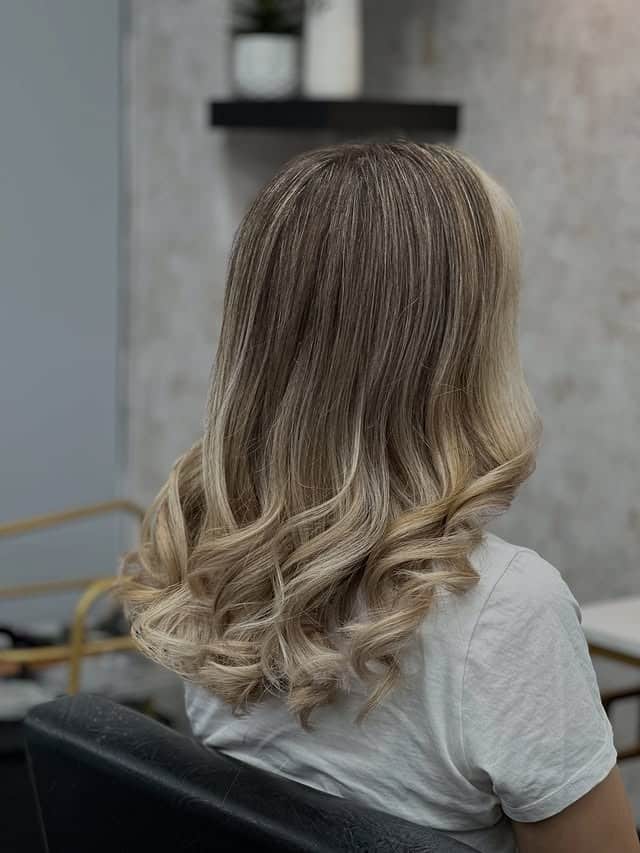 14. Long Feather Curls in Sandy Blonde - Feather Haircuts For Women