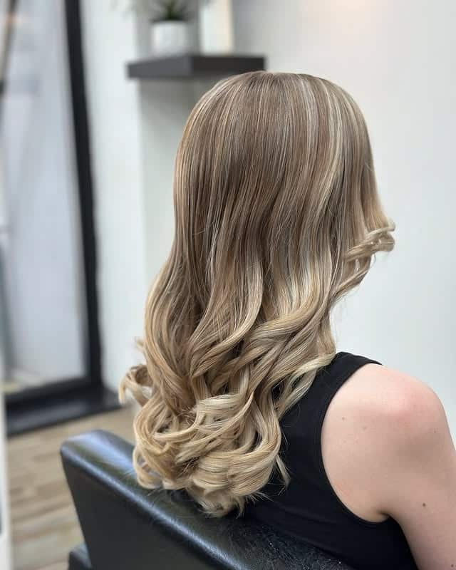 16. Glossy Feather Layers with Champagne Blonde Blend - Feather Haircuts For Women